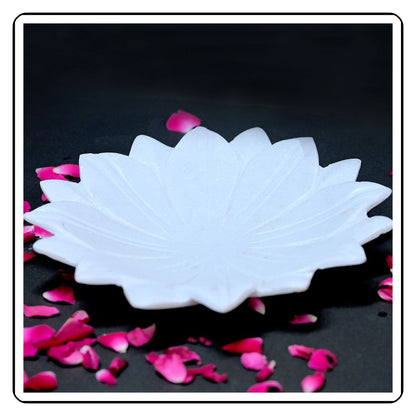 Close-up of a flower-designed marble urli, with a smooth, polished finish and floral detailing."