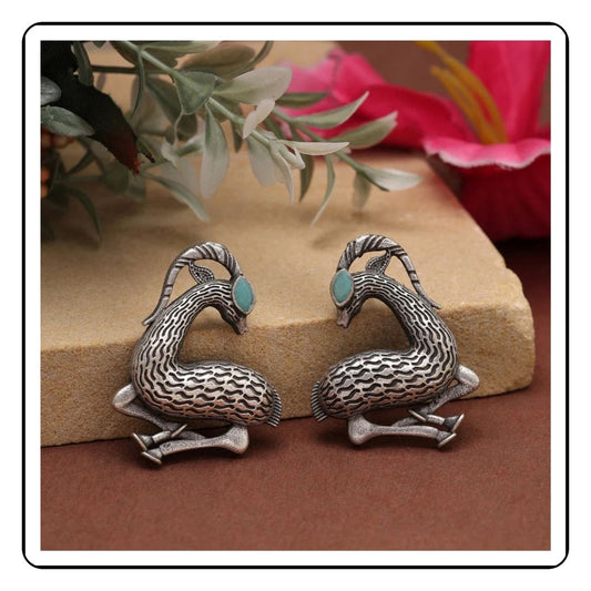 Pair of deer-themed blue oxidized earrings with intricate detailing, showcasing a rustic and antique finish.